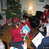 Mes petits cousins, Fr�d�rique, Marie-�ve et �tienne, developpant leur cadeau sous le regard amus� de leur m�re, Tante Lorraine.
2005-12-24